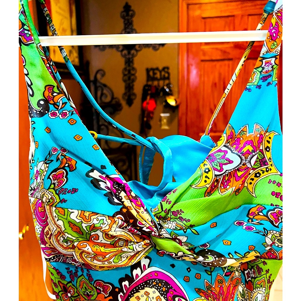 Great resort or eveningwear. Size 6 main color is turquoise never been worn.